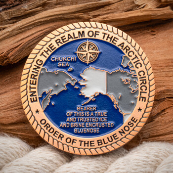 Order of the Blue Nose challenge coin featuring a map of the Arctic Circle, Chukchi Sea, and a compass rose on a blue background with a copper rope border.