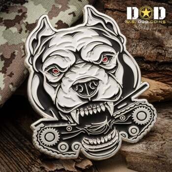 Custom die-cast challenge coin shaped like a white pit bull head with red eyes biting down on a mechanical tank tread.