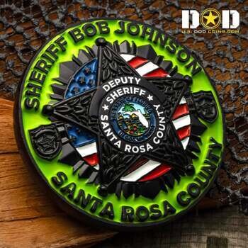 Circular challenge coin featuring Sheriff Bob Johnson and Santa Rosa County text, a 5-point star, and the Florida state seal over a green background.