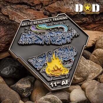Hexagonal challenge coin featuring blue mountains, northern lights, and a yellow flame with 11th AF and Arctic Resiliency Training text.