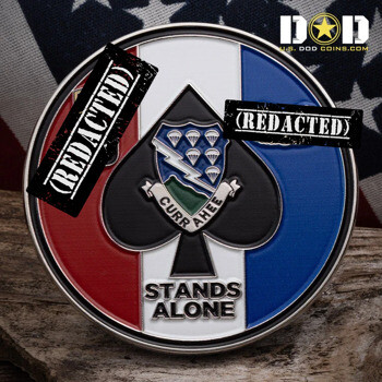 Round challenge coin with red, white, and blue background featuring a black spade, lightning bolt shield, and parachutes.