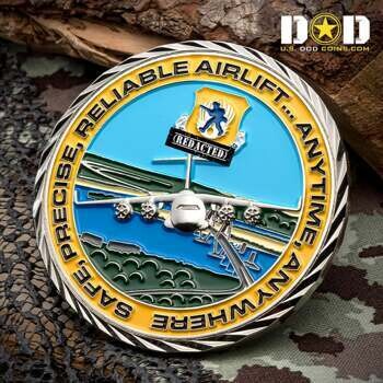 Round challenge coin featuring a C-17 transport aircraft over a landscape with a blue and yellow outer ring.