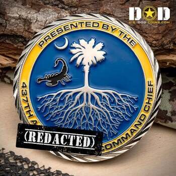 Round challenge coin featuring a palmetto tree with deep roots, a scorpion, and a crescent moon on a blue background with a yellow outer ring.