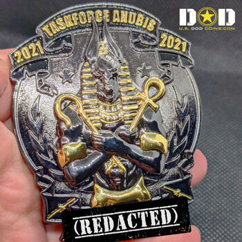 Black nickel challenge coin featuring a gold-accented Anubis figure holding a crook and flail with Taskforce Anubis 2021 text.