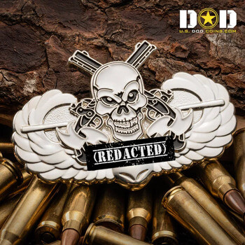 Custom challenge coin shaped like a winged skull with crossed rifles over a background of ammunition casings.