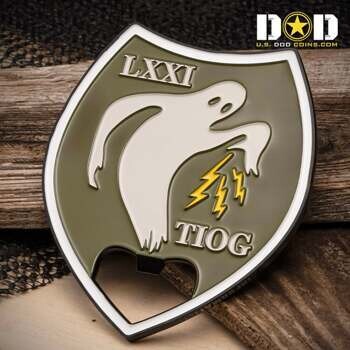 Shield-shaped bottle opener challenge coin featuring a ghost icon, yellow lightning bolts, and the text LXXI TIOG on an olive drab background.