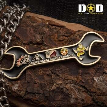 Wrench-shaped challenge coin for Grand Slam Maintenance featuring a genie, horse head, and American flag on a black background.