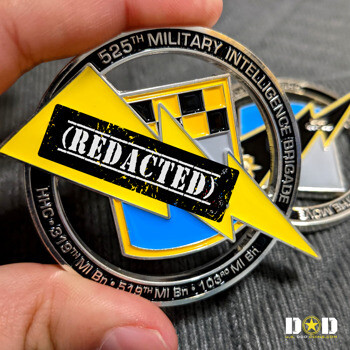 Circular challenge coin for the 525th Military Intelligence Brigade featuring a yellow lightning bolt and checkered shield design.