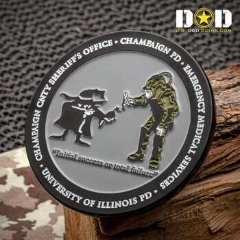 Challenge coin featuring EOD bomb technician and Spy vs. Spy illustrations with University of Illinois and Champaign PD text.