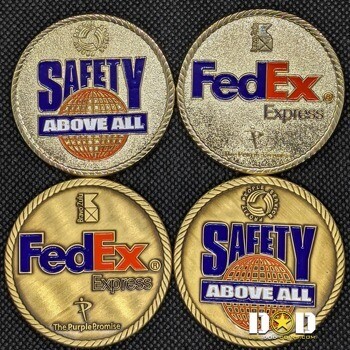 Gold FedEx Express and Safety Above All challenge coins with blue and orange enamel and rope borders.