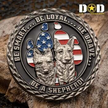 A round metal challenge coin featuring two German Shepherds inside a paw print with an American flag background and a textured diamond-cut edge.