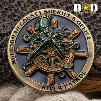 Circular challenge coin featuring a green metallic octopus over a wooden ship's wheel with Multnomah County Sheriff's Office River Patrol text.