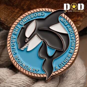 Circular challenge coin featuring a black and white orca over a blue background with the text Crossing the Arctic Boundary & Other Mandatory Fun.