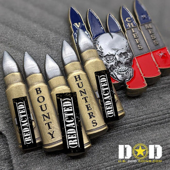Bullet-shaped challenge coins with silver tips, brass casings, and a skull design featuring red and blue enamel accents.