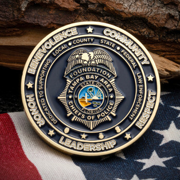 Gold and blue challenge coin for Tampa Bay Area Chiefs of Police Foundation featuring an eagle emblem and Florida state seal over an American flag.