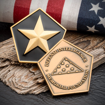 Pentagon-shaped challenge coin featuring a gold star on black enamel and a folded flag emblem for the Defense Intelligence Memorial Foundation.