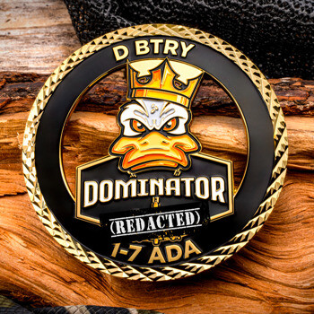 Custom challenge coin featuring an angry duck in a crown with D BTRY DOMINATOR 1-7 ADA text and a textured gold rim.
