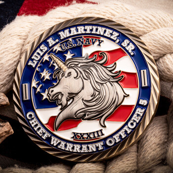 US Navy Chief Warrant Officer 5 challenge coin featuring a unicorn head over an American flag design with rope and wood accent background.