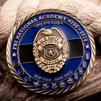 FBI National Academy and U.S. Navy Security Forces challenge coin with gold badge emblem and American flag background.