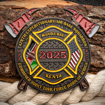 Custom challenge coin featuring a firefighter Maltese cross, crossed axes, Kenyan and US flags, and text for Manda Bay Kenya 2025.