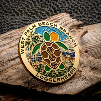 Gold challenge coin featuring a loggerhead turtle, palm trees, and ocean scene for West Palm Beach Branch Loggerheads.