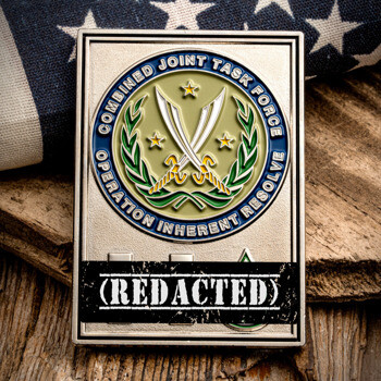 Rectangular silver challenge coin for Combined Joint Task Force Operation Inherent Resolve featuring crossed scimitars, a laurel wreath, and a redacted name pla