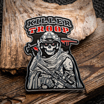 Killer Troop custom lapel pin featuring a skeleton soldier with night vision goggles, a rifle, and a blood-stained axe on a wooden background.