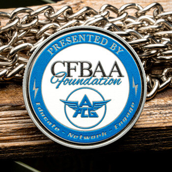 Circular CFBAA Foundation challenge coin with blue and white enamel, featuring a winged ACG logo on a wood and chain background.