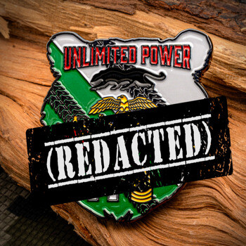 Shield-shaped lapel pin featuring the text Unlimited Power with a panther and eagle emblem over a green and white background.