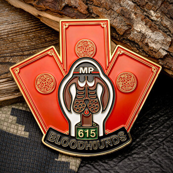 Shield-shaped challenge coin featuring a bloodhound head, the letters MP, number 615, and Bloodhounds text on a red and gold enamel background.