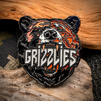 Soft enamel lapel pin featuring a detailed grizzly bear head with the text Grizzlies in its mouth.
