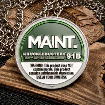 Circular green and white challenge coin with silver text for Knucklebusters 91B 133rd MP Co Mechanics on a wood block with a silver chain.
