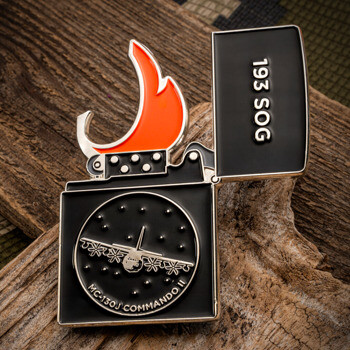 Lighter-shaped lapel pin featuring 193 SOG text, an orange flame, and an MC-130J Commando II aircraft on a black background.