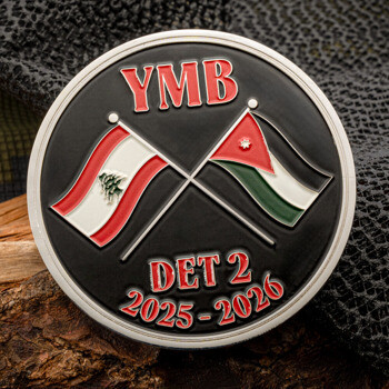 Circular black challenge coin featuring YMB and DET 2 text with crossed flags of Lebanon and Jordan over a black background.