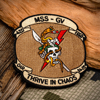 Embroidered tactical patch featuring a skull, snake, and lightning bolt on a tan background with 'MSS - GV' and 'Thrive in Chaos' text.