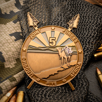 Antique bronze challenge coin featuring a camel, spears, and sunburst design for Joint Forces Djibouti Africa Five.
