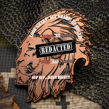Antique copper lion-shaped challenge coin featuring a redacted stamp and tactical slogans over a camouflage background.