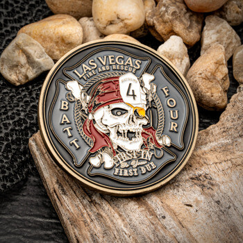 Circular challenge coin for Las Vegas Fire and Rescue Batt Four featuring a pirate skull with an eyepatch on a black and gold background.
