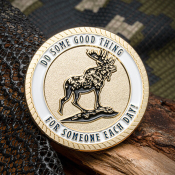 Gold and white challenge coin featuring a bull moose and the text Do Some Good Thing For Someone Each Day.
