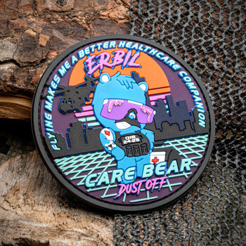 Circular PVC patch featuring a blue bear in tactical gear with a sunset and helicopter background, labeled Erbil Care Bear Dust Off.