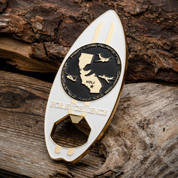 Surfboard shaped challenge coin with bottle opener, featuring a California map and aircraft silhouettes for ASF Los Alamitos KSLI.