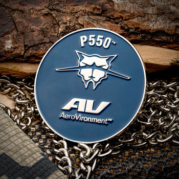 AeroVironment P550 challenge coin with blue enamel and silver cat emblem resting on a metal chain.
