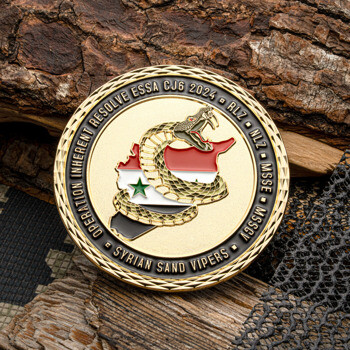 Gold challenge coin featuring a viper coiled around a map of Syria with a diamond-cut edge.