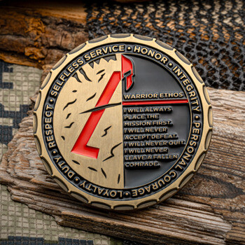 Antique brass challenge coin featuring a red Spartan helmet, the Warrior Ethos text, and values like Honor and Integrity on the outer rim.