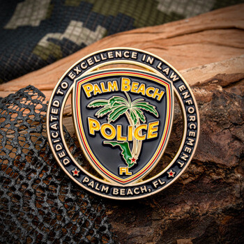 A circular challenge coin for Palm Beach Police featuring a palm tree emblem on a black shield with gold lettering and a border dedicated to law enforcement.