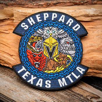 Embroidered patch featuring the text Sheppard Texas MTLA with an owl, cobra, bull, tiger, and gorilla surrounding a gold helmet.