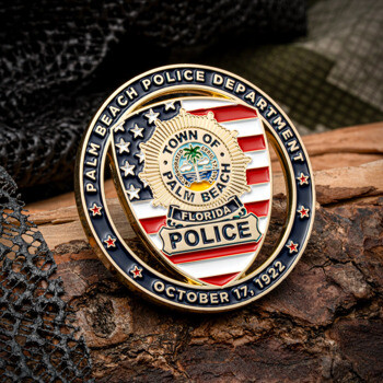 Palm Beach Police Department challenge coin with American flag backdrop and police badge emblem.