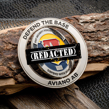 Silver spinner challenge coin for the 31st Security Forces Squadron at Aviano Air Base with red, blue, and yellow enamel shield.