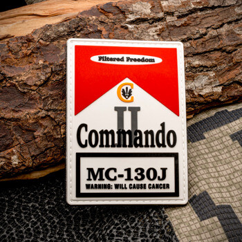 Rectangular PVC patch styled like a cigarette pack with 'Commando MC-130J' text on a red and white background.