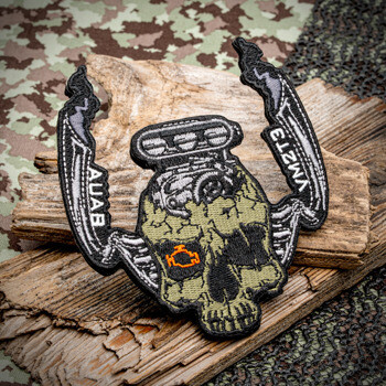 Embroidered patch featuring a green skull with an engine blower and check engine light eye, flanked by wings with AUAB and YM2T3 text.